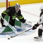 Dallas Stars goaltender Jake Oettinger (29) defends the goal against Arizona Coyotes left wing Michael Carcone (53) during the second period of an NHL hockey game in Dallas, Saturday, Jan. 21, 2023. (AP Photo/LM Otero)