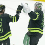 Dallas Stars goaltender Jake Oettinger (29) is congratulated by defenseman Colin Miller (6) at the end of the third period of an NHL hockey game against the Arizona Coyotes in Dallas, Saturday, Jan. 21, 2023. (AP Photo/LM Otero)
