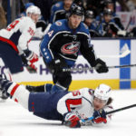 Washington Capitals forward Sonny Milano, right, dives for the puck in front of Columbus Blue Jackets forward Cole Sillinger during the second period of an NHL hockey game in Columbus, Ohio, Tuesday, Jan. 31, 2023. (AP Photo/Paul Vernon)