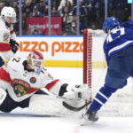 Florida Panthers goaltender Sergei Bobrovsky (72) makes a save on Toronto Maple Leafs forward Pierre Engvall (47) as defenseman Aaron Ekblad (5) watches during the second period of an NHL hockey game Tuesday, Jan. 17, 2023, in Toronto. (Nathan Denette/The Canadian Press via AP)