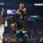 
              Golden State Warriors guard Stephen Curry shoots as  Phoenix Suns guard Josh Okogie, front left, defends during the first half of an NBA basketball game in San Francisco, Tuesday, Jan. 10, 2023. (AP Photo/Godofredo A. Vásquez)
            