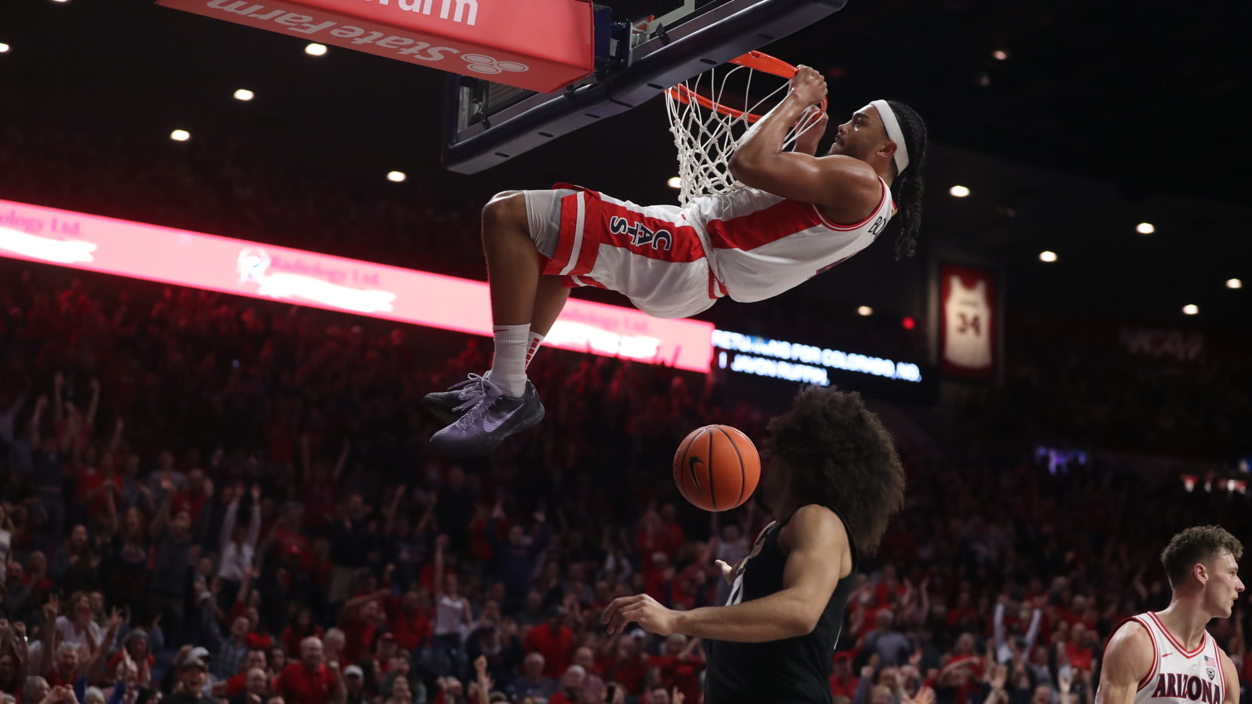 Arizona Wildcats guard Kylan Boswell #4 gets a technical foul for hanging on the rim after a dunk d...