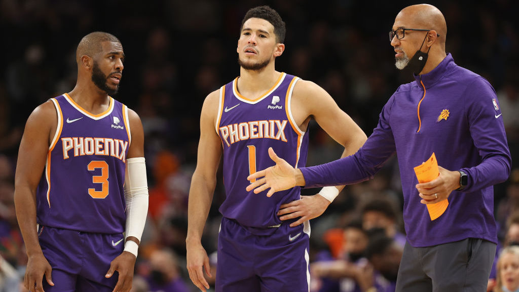 Head coach Monty Williams of the Phoenix Suns talks with Chris Paul #3 and Devin Booker #1 during t...