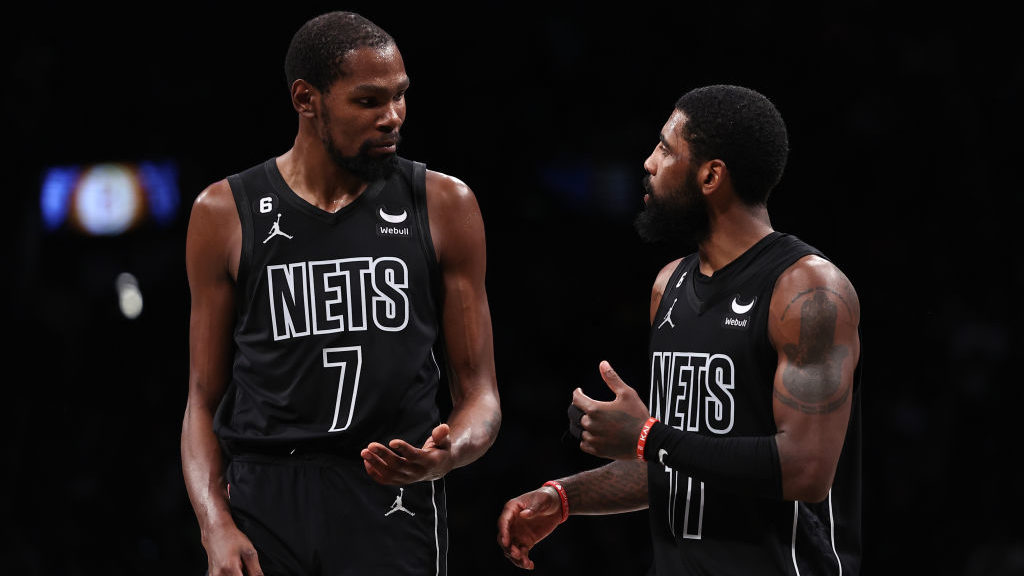 Kyrie Irving #11 and Kevin Durant #7 of the Brooklyn Nets talk during a break in the action during ...