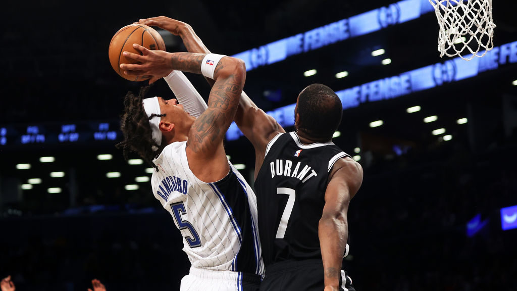 Kevin Durant #7 of the Brooklyn Nets blocks a shot by Paolo Banchero #5 of the Orlando Magic during...