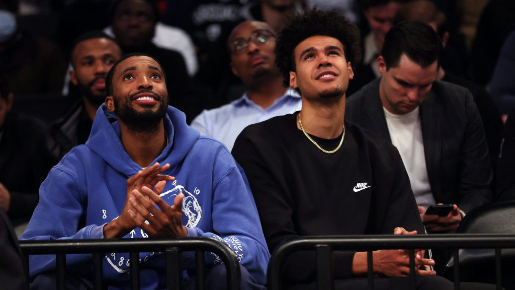 New Nets players Mikal Bridges and Cam Johnson watch from the crowd after being traded for Kevin Du...