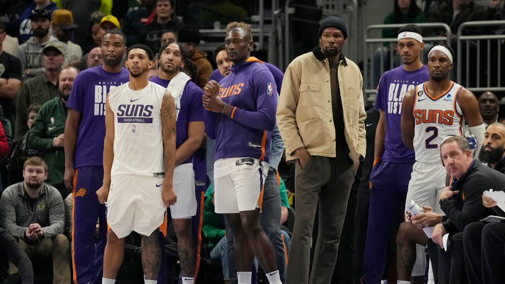Kevin Durant #35 of the Phoenix Suns (R) watches play in the second half against the Milwaukee Buck...