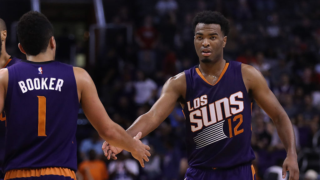 TJ Warren #12 of the Phoenix Suns high fives Devin Booker #1 after scoring against the Portland Tra...