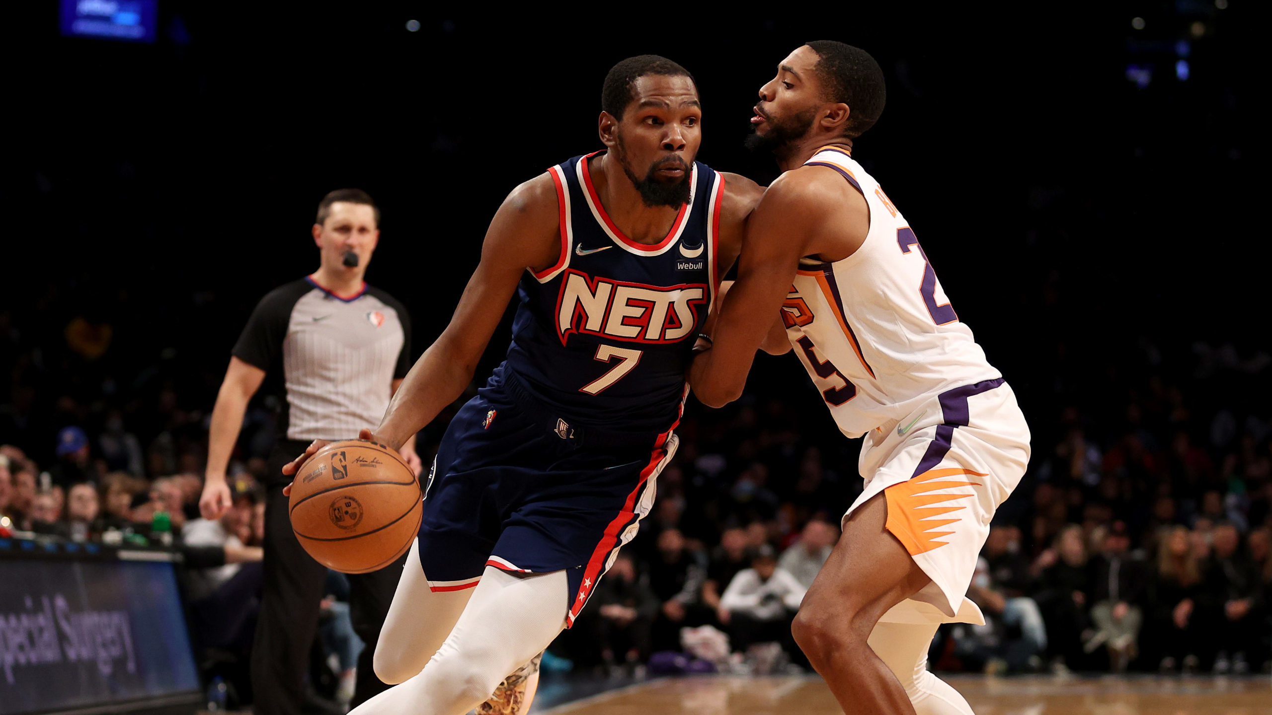 Kevin Durant #7 of the Brooklyn Nets heads for the net as Mikal Bridges #25 of the Phoenix Suns def...