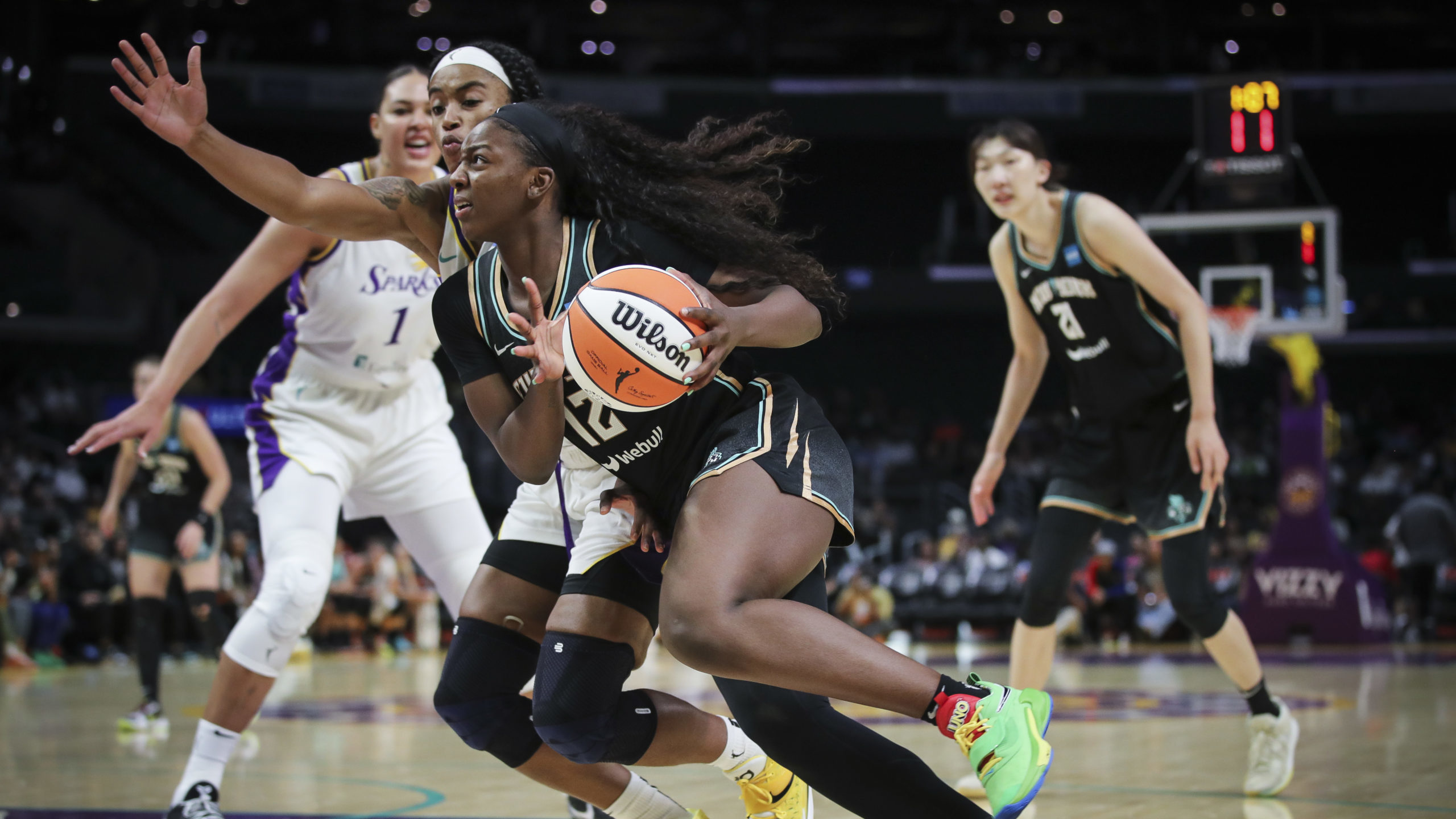 Michaela Onyenwere #12 of the New York Liberty drives to the basket defended by Jasmine Walker #40 ...
