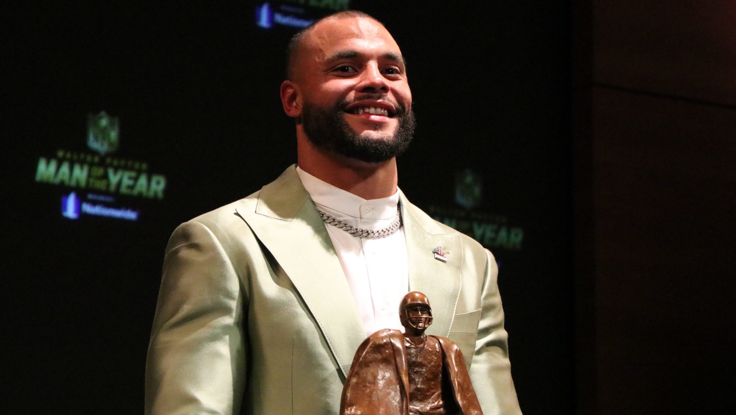 Dak Prescott talks with reporters after being named the Walter Payton NFL Man of the Year at the NF...