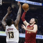
              Cleveland Cavaliers forward Cedi Osman shoots against Denver Nuggets center Thomas Bryant (13) during the first half of an NBA basketball game, Thursday, Feb. 23, 2023, in Cleveland. (AP Photo/Ron Schwane)
            