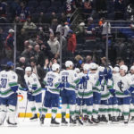 The Vancouver Canucks celebrate after an NHL hockey game against the New York Islanders on Thursday, Feb. 9, 2023, in Elmont, N.Y. (AP Photo/Frank Franklin II)