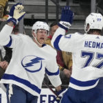 Tampa Bay Lightning right wing Corey Perry, left, celebrates after scoring against the Vegas Golden Knights during the second period of an NHL hockey game Saturday, Feb. 18, 2023, in Las Vegas. (AP Photo/John Locher)