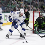 
              Tampa Bay Lightning center Anthony Cirelli (71) attempts to make a pass to the front of the net as Dallas Stars' Miro Heiskanen (4) and goalie Scott Wedgewood (41) defend in the second period of an NHL hockey game, Saturday, Feb. 11, 2023, in Dallas. (AP Photo/Tony Gutierrez)
            