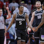 
              Referee Gediminas Petraitis, left, signals one more free throw as Sacramento Kings guard De'Aaron Fox (5) is congratulated by Malik Monk (0) and Domantas Sabonis (10) after Fox hit the go-ahead free throw in the final second of an NBA basketball game Wednesday, Feb. 8, 2023, in Houston. (AP Photo/Michael Wyke)
            