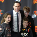 
              Mat Ishbia, the new controlling interest owner of the Phoenix Suns and Phoenix Mercury, poses with his children as he is introduced to the media during an NBA basketball news conference, Wednesday, Feb. 8, 2023, in Phoenix. (AP Photo/Rick Scuteri)
            