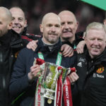 
              Manchester United's head coach Erik ten Hag, centre, and team members pose with the trophy after the English League Cup final soccer match between Manchester United and Newcastle United at Wembley Stadium in London, Sunday, Feb. 26, 2023. (AP Photo/Alastair Grant)
            