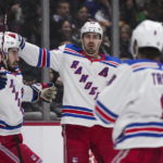 New York Rangers' Chris Kreider, center, Mika Zibanejad, left, and Jacob Trouba celebrate Kreider's goal against the Vancouver Canucks during the second period of an NHL hockey game Wednesday, Feb. 15, 2023, in Vancouver, British Columbia. (Darryl Dyck/The Canadian Press via AP)