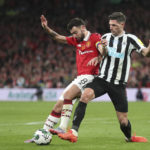 Newcastle's Fabian Schaer, right, fights for the ball with Manchester United's Bruno Fernandes during the English League Cup final soccer match between Manchester United and Newcastle United at Wembley Stadium in London, Sunday, Feb. 26, 2023. (AP Photo/Scott Heppell)