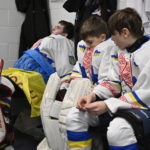 
              Ukraine hockey players Mati Kulish, left to right, Dmytro Korzh and Maksym Kukharenko react after losing their match against Vermont Flames Academy at the International Peewee Tournament in Quebec City, Friday, Feb. 17, 2023.  (Jacques Boissinot/The Canadian Press via AP)
            