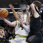 Purdue guard Braden Smith (3) passes the ball against Northwestern center Matthew Nicholson, right, during the first half of an NCAA college basketball game in Evanston, Ill., Sunday, Feb. 12, 2023. (AP Photo/Nam Y. Huh)