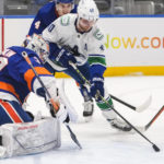 
              New York Islanders goaltender Ilya Sorokin (30) stops a shot by Vancouver Canucks' Elias Pettersson (40) during the first period of an NHL hockey game Thursday, Feb. 9, 2023, in Elmont, N.Y. (AP Photo/Frank Franklin II)
            