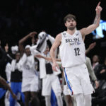 
              Brooklyn Nets forward Joe Harris (12) reacts after scoring a 3-point basket during the first half of the team's NBA basketball game against the Chicago Bulls, Thursday, Feb. 9, 2023, in New York. (AP Photo/Mary Altaffer)
            