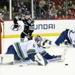 
              CORRECTS MONTH TO FEB. NOT JAN. - Vancouver Canucks goaltender Collin Delia, front left, stops the puck as New Jersey Devils left wing Jesper Bratt (63) watches on during the second period of an NHL hockey game, Monday, Feb. 6, 2023, in Newark, N.J. (AP Photo/Bill Kostroun)
            