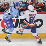 
              New York Islanders' Kyle Palmieri checks Montreal Canadiens' Rafael Harvey-Pinard (49) during the second period of an NHL hockey game in Montreal, Saturday, Feb. 11, 2023. (Graham Hughes/The Canadian Press via AP)
            