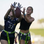 
              FILE - Aly Young, 17, left, and Shale Harris, 15, reach to catch a pass as they try out for the Redondo Union High School girls flag football team on Thursday, Sept. 1, 2022, in Redondo Beach, Calif. California officials are expected to vote Friday on the proposal to make flag football a girls' high school sport for the 2023-24 school year. (AP Photo/Ashley Landis, File)
            