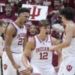 
              Indiana's Trayce Jackson-Davis (23) reacts with Miller Kopp (12) and Trey Galloway, right, after Jackson-Davis hit a basket and was fouled during the first half of an NCAA college basketball game against Purdue, Saturday, Feb. 4, 2023, in Bloomington, Ind. (AP Photo/Darron Cummings)
            