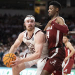 South Carolina forward Hayden Brown (10) looks for a shot against Alabama forward Brandon Miller (24) during the second half of an NCAA college basketball game Wednesday, Feb. 22, 2023, in Columbia, S.C. Alabama won 78-76 in overtime. (AP Photo/Sean Rayford)