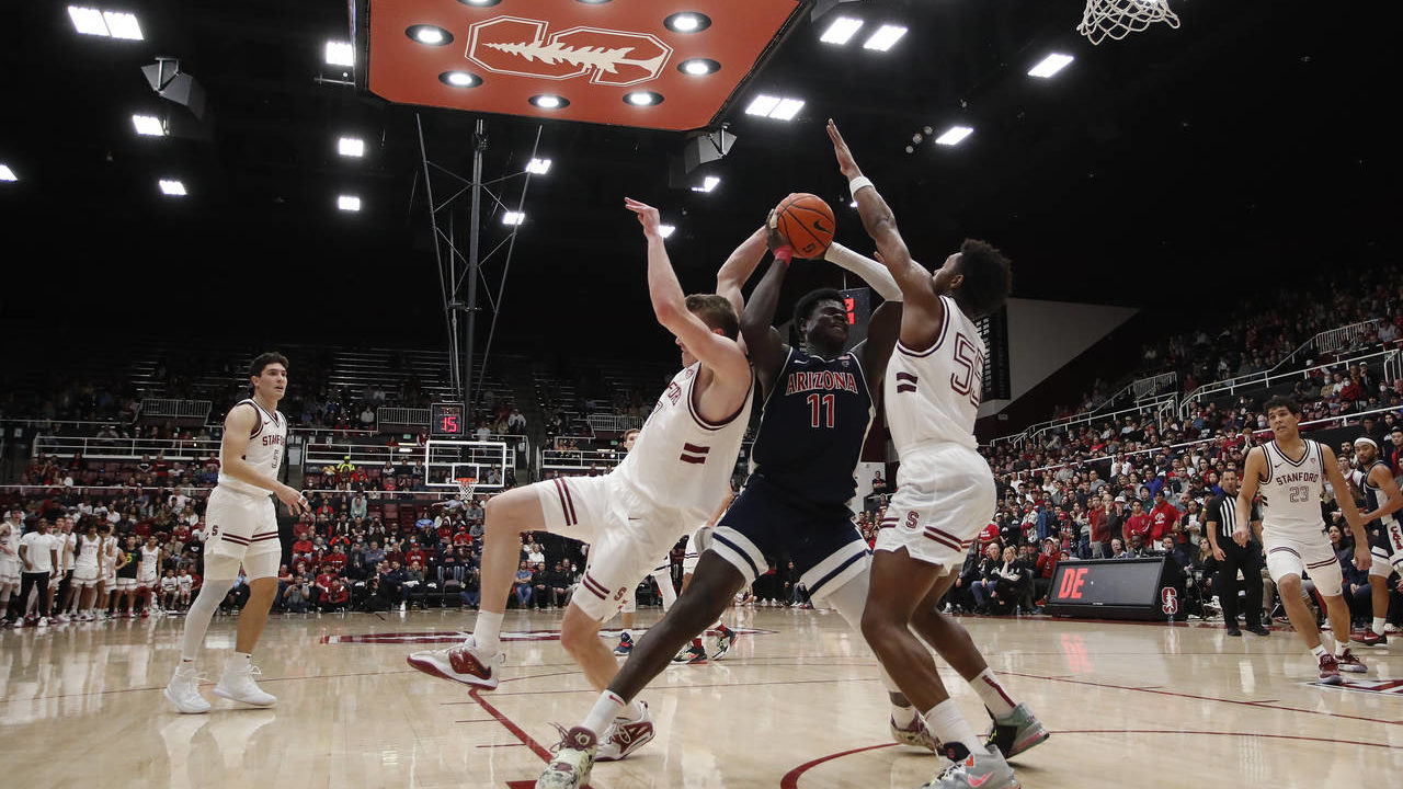 Arizona center Oumar Ballo (11) drives to the hoop against Stanford guard Jarvis Moss, front left, ...