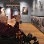 
              Sister Jean Dolores Schmidt looks at family photos hanging in a museum gallery dedicated to the now 103-year-old Catholic nun, at Loyola University on Tuesday, Jan. 24, 2023, in Chicago. (AP Photo/Jessie Wardarski)
            