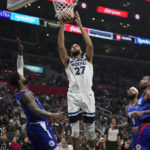 
              Minnesota Timberwolves center Rudy Gobert (27) grabs a rebound next to Los Angeles Clippers forward Paul George, left, forward Marcus Morris Sr. (8) and forward Kawhi Leonard (2) during the first half of an NBA basketball game Tuesday, Feb. 28, 2023, in Los Angeles. (AP Photo/Marcio Jose Sanchez)
            