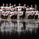 The 2003 Stanley Cup Champion New Jersey Devils pose for a team photo after a ceremony honoring the 20-year anniversary before an NHL hockey game against the Philadelphia Flyers, Saturday, Feb. 25, 2023, in Newark, N.J. (AP Photo/Adam Hunger)