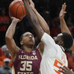 Florida State guard Matthew Cleveland (35) aims for a basket as Miami guard Wooga Poplar (55) defends during the first half of an NCAA college basketball game, Saturday, Feb. 25, 2023, in Coral Gables, Fla. (AP Photo/Marta Lavandier)
