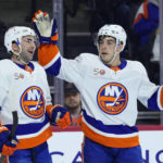 New York Islanders' Kyle Palmieri, left, and Jean-Gabriel Pageau celebrate after a goal by Palmieri during the first period of an NHL hockey game against the Philadelphia Flyers, Monday, Feb. 6, 2023, in Philadelphia. (AP Photo/Matt Slocum)