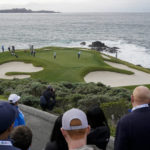 Joseph Bramlett, middle, follows his putt on the 7th green of the Pebble Beach Golf Links during the third round of the AT&T Pebble Beach Pro-Am golf tournament in Pebble Beach, Calif., Saturday, Feb. 4, 2023. (AP Photo/Godofredo A. Vásquez)
