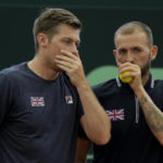 Dan Evans, right, and Neal Skupski of Britain, discuss strategy during their Davis Cup qualification doubles match against Robert Farah and Juan Sebastian Cabal of Colombia, in Cota, Colombia, Saturday, Feb. 4, 2023. (AP Photo/Fernando Vergara)