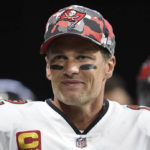 FILE - Tampa Bay Buccaneers quarterback Tom Brady (12) smiles during warmups before an NFL football game, Sunday, Jan. 8, 2023, in Atlanta.  Brady, who won a record seven Super Bowls for New England and Tampa, has announced his retirement, Wednesday, Feb. 1, 2023. 
 (AP Photo/Hakim Wright Sr., File)