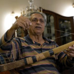 
              Pakistan's legendary field hockey player Samiullah shows a souvenir hockey stick during an interview with The Associated Press, in Karachi, Pakistan, Saturday, Nov. 12, 2022. There is only one sport that matters in Pakistan and that's cricket, a massive money-making machine. But minors sports like rugby are struggling to get off the ground due to lack of investment and interest, stunting their growth at home and chances of success overseas. Even previously popular sports like squash and field hockey, which Pakistan dominated for decades, can't find their form.(AP Photo/Fareed Khan)
            