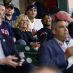 
              FILE - First lady Jill Biden and Doug Emhoff sit with military members and first responders as they attend a baseball game between the Houston Astros and the Baltimore Orioles at Minute Maid Park, in Houston,  June 29, 2021. (AP Photo/Carolyn Kaster, Pool, File)
            
