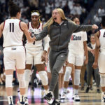 UConn's Paige Bueckers, center, reacts after UConn's Lou Lopez-Senechal, left, hit a 3 points basket at the end of the first quarter in the first half of an NCAA college basketball game against South Carolina, Sunday, Feb. 5, 2023, in Hartford, Conn. (AP Photo/Jessica Hill)