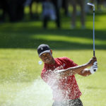 FILE -  Tiger Woods hits out of a greenside bunker on the 17th hole during the final round of the Genesis Invitational golf tournament at Riviera Country Club, Sunday, Feb. 16, 2020, in the Pacific Palisades area of Los Angeles. Woods is back at Riviera, this time with more on his plate than handing out the trophy in the Genesis Invitational. He returns to the PGA Tour for the first time since July. (AP Photo/Ryan Kang, File)