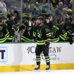 
              Dallas Stars left wing Jamie Benn (14) celebrates at the bench after scoring in the second period of an NHL hockey game against the Tampa Bay Lightning, Saturday, Feb. 11, 2023, in Dallas. (AP Photo/Tony Gutierrez)
            