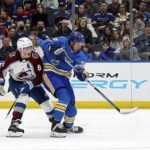 
              St. Louis Blues' Jake Neighbours (63) takes a short on goal while under pressure from Colorado Avalanche's Cale Makar (8) during the second period of an NHL hockey game Saturday, Feb. 18, 2023, in St. Louis. (AP Photo/Scott Kane)
            