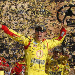 
              FILE - NASCAR Sprint Cup Series driver Joey Logano celebrates his victory in the Hollywood Casino 400 at Kansas Speedway in Kansas City, Kan., Sunday, Oct. 5, 2014. (AP Photo/Colin E. Braley, File)
            