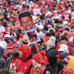A fan waves a sign with Patrick Mahomes' photo on it during the Kansas City Chiefs' victory celebration and parade in Kansas City, Mo., Wednesday, Feb. 15, 2023.  The Chiefs defeated the Philadelphia Eagles Sunday in the NFL Super Bowl 57 football game. (AP Photo/Reed Hoffman)